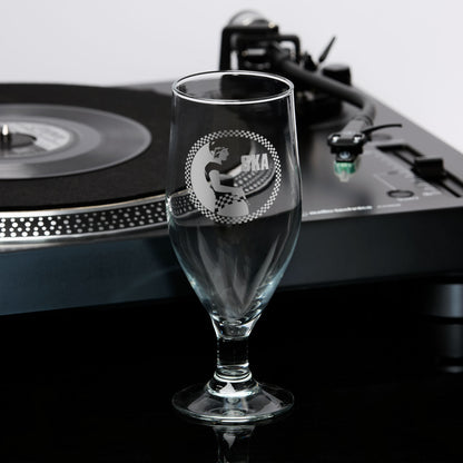 Engraved stemmed beer glass featuring a Rude Girl in checkerboard skirt, with circular checker border and Ska text