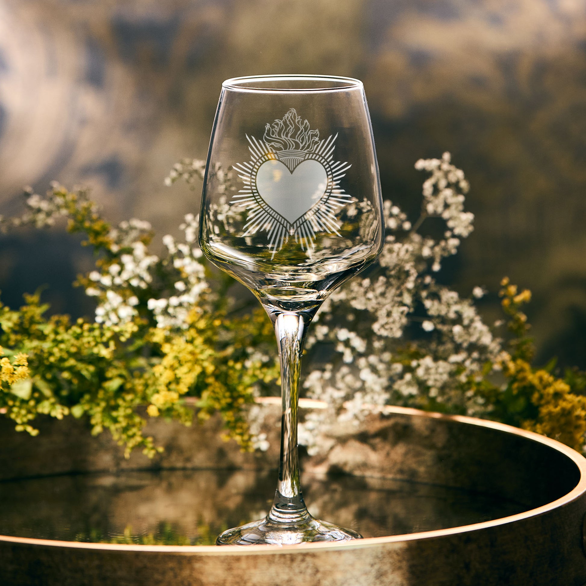 Wine glass engraved with a sacred milagro heart, also known as a "Sagrado Corazón" or "Sacred Heart" in Spanish
