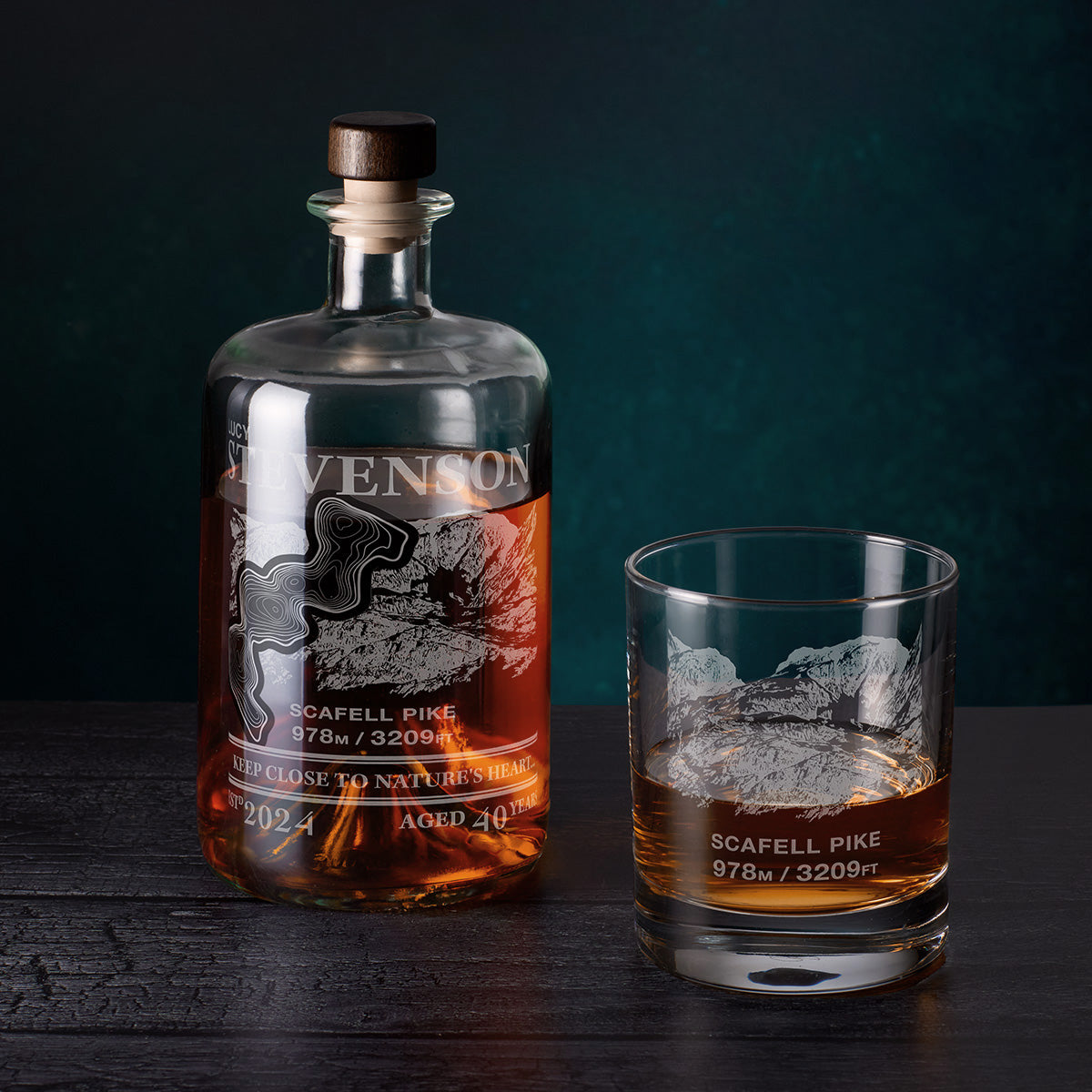 Scafell Pike Engraved Bottle and glass of whiskey on a dark background
