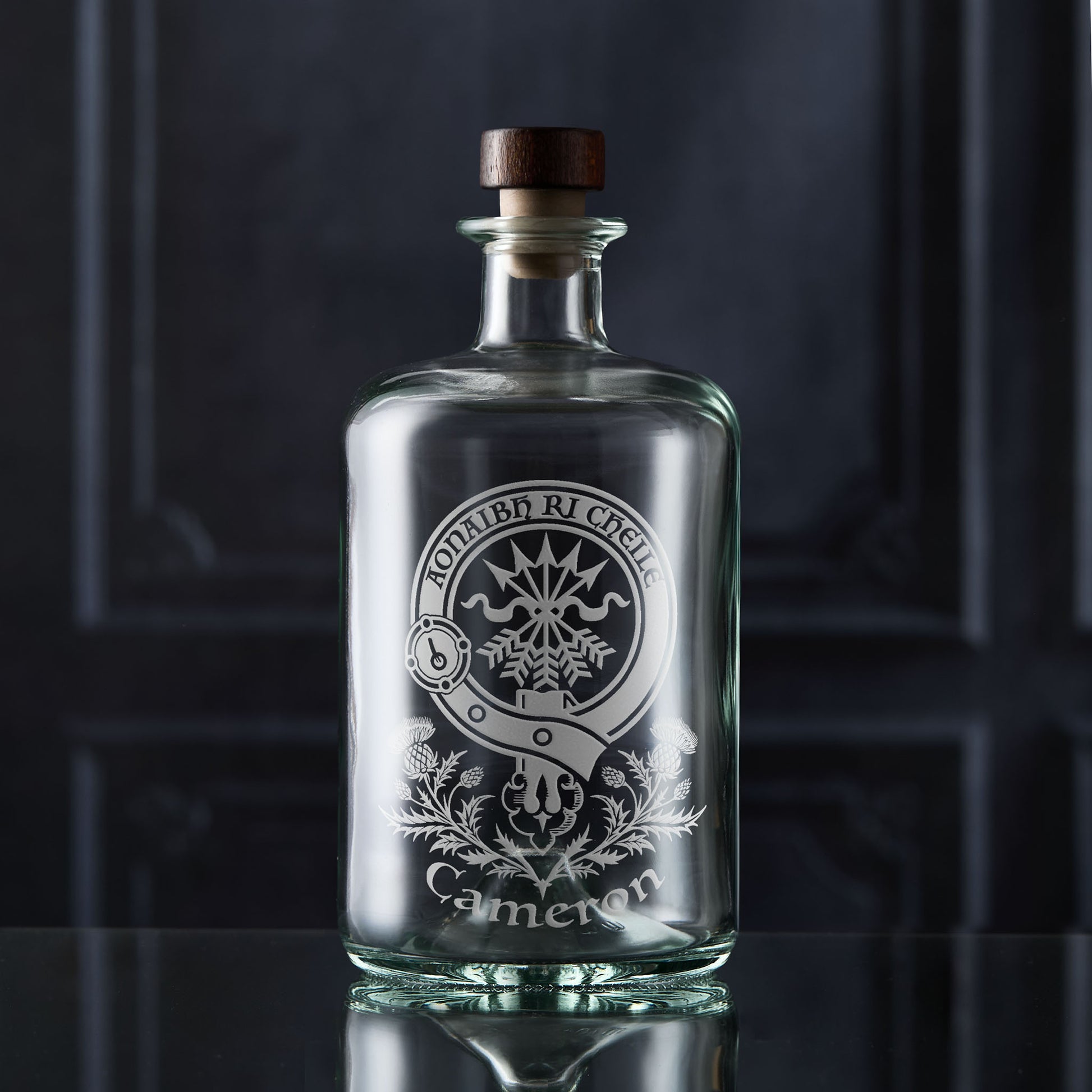 Scottish Clan Crest whisky decanter in an apothecary style engraved with the Cameron family's clan surrounded by thistles