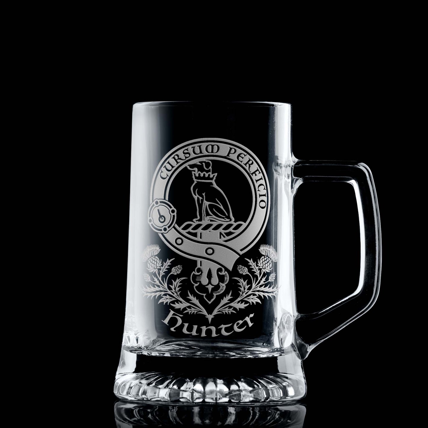 Glass tankard with engraved Clan Hunter crest and scottish thistles design on a black background