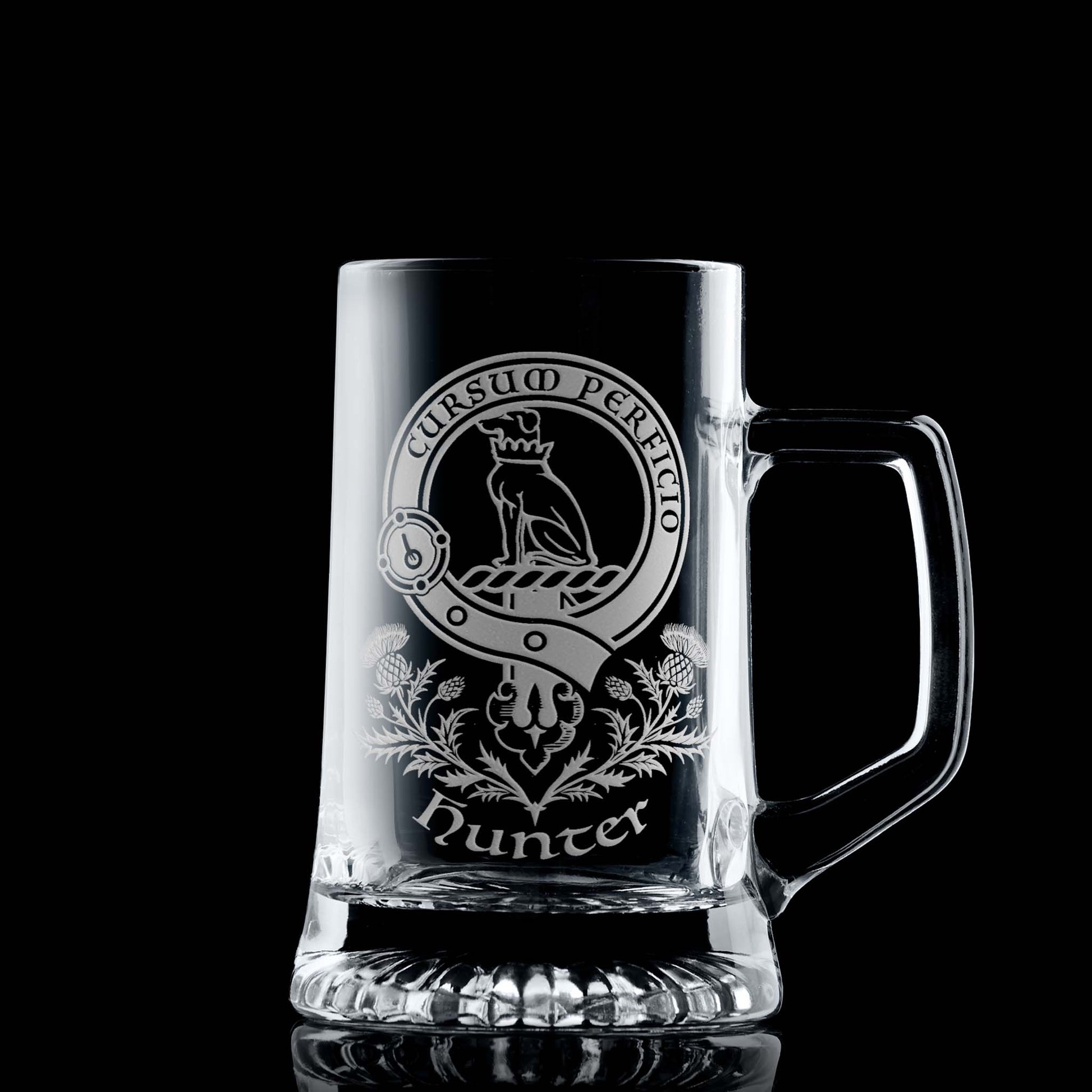 Glass tankard with engraved Clan Hunter crest and scottish thistles design on a black background