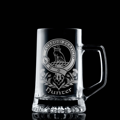 Glass tankard with engraved Clan Hunter crest and scottish thistles design on a black background