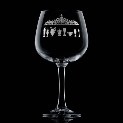 Engraved Liverpool gin glass with Shankly Gates and trophy silhouettes, shown on a black background to highlight fine engraving detail