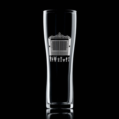 Engraved pint glass with Shankly Gates entrance to a Livepool football stadium and trophy silhouettes, shown front-facing on a black background.