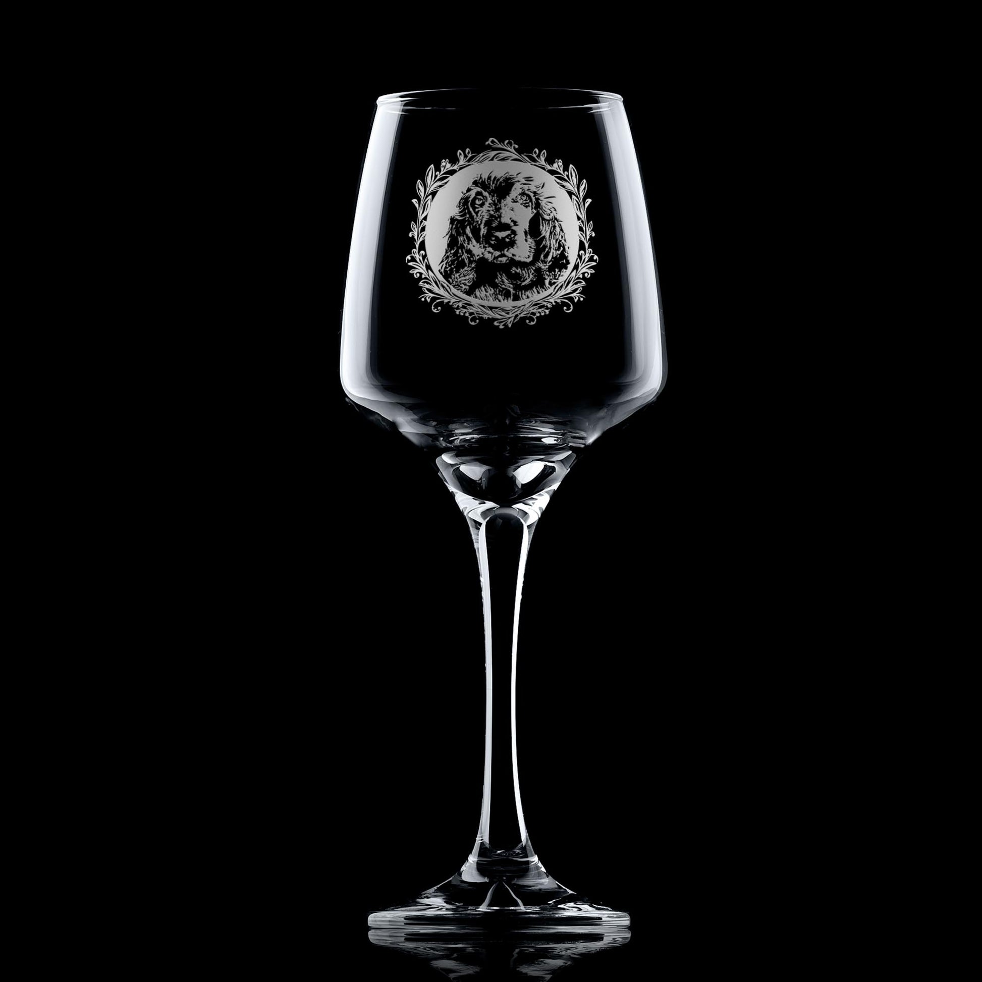 Stemmed wine glass with engraved show cocker spaniel framed with leafy garland