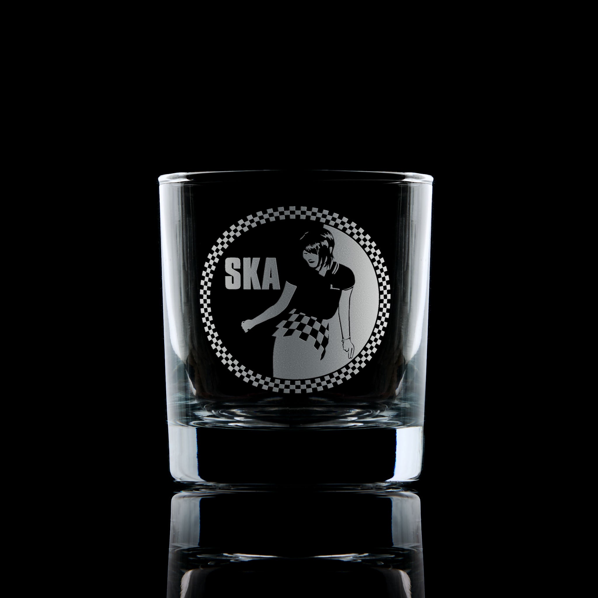 Whisky glass engraved with a Rude Girl in checkerboard skirt and Ska text – circular design with border in 2 Tone style