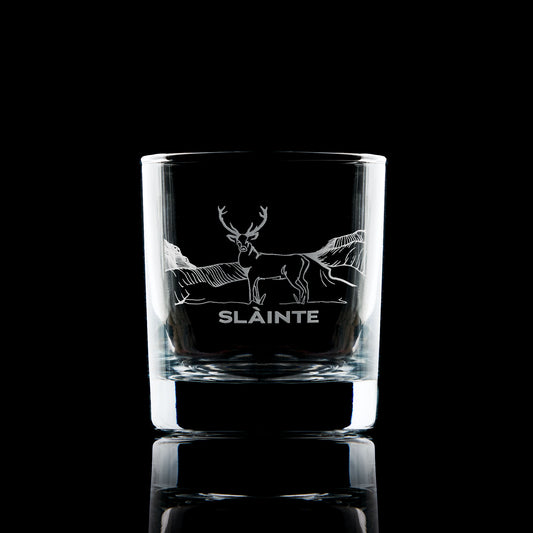 whisky glass engraved with a stag in the scottish mountains