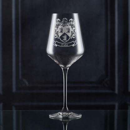 Hand-engraved wine glass with family crest — satin sandblasted finish on fine stemware.