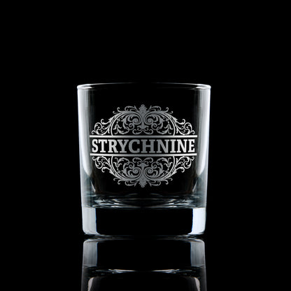 Strychnine engraved whisky glass photographed on a dark background