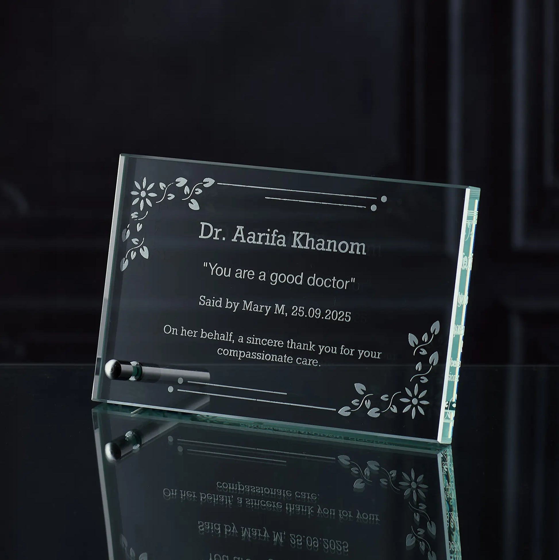 Glass plaque with engraved thankyou and personalised text on a dark background