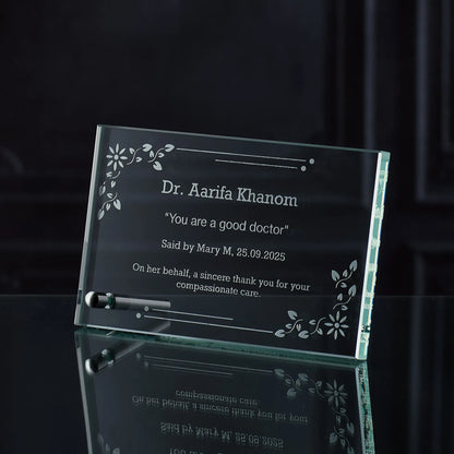 Glass plaque with engraved thankyou and personalised text on a dark background