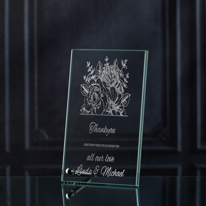 Glass plaque with floral design and engraved thankyou text on a dark background