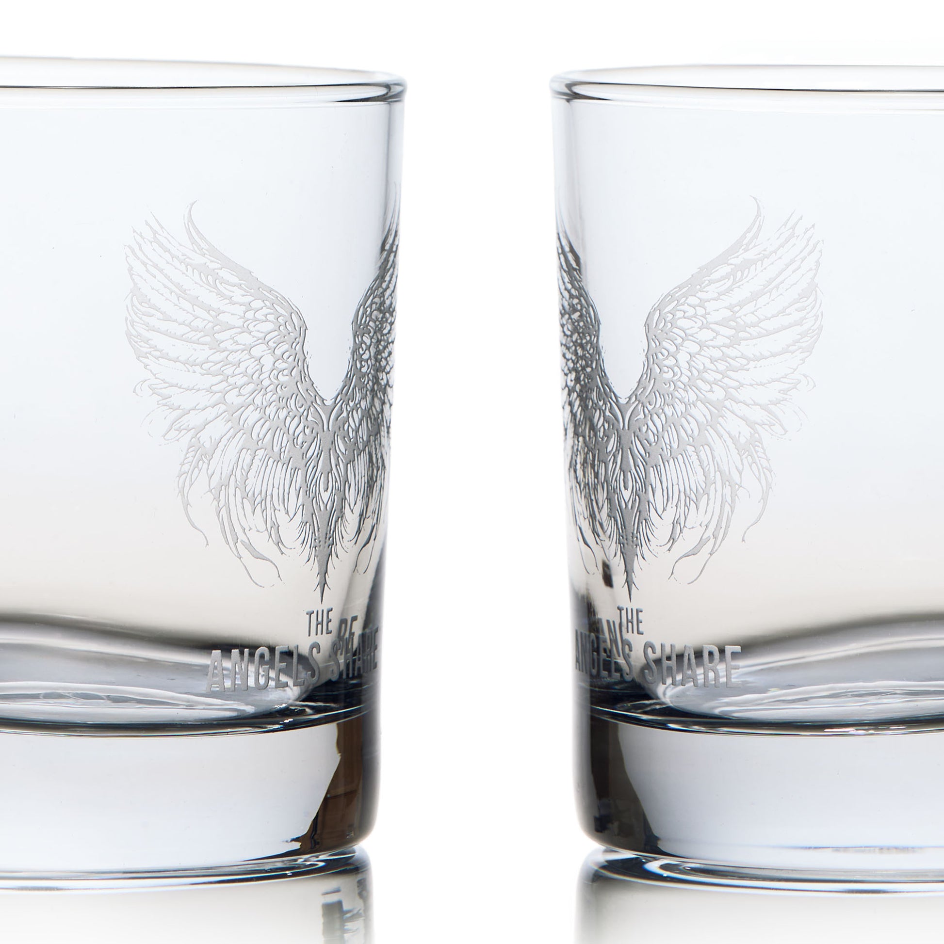 Side view of an engraved whisky glass illustrated with a pair of angels wings and the words 'The Angels Share'
