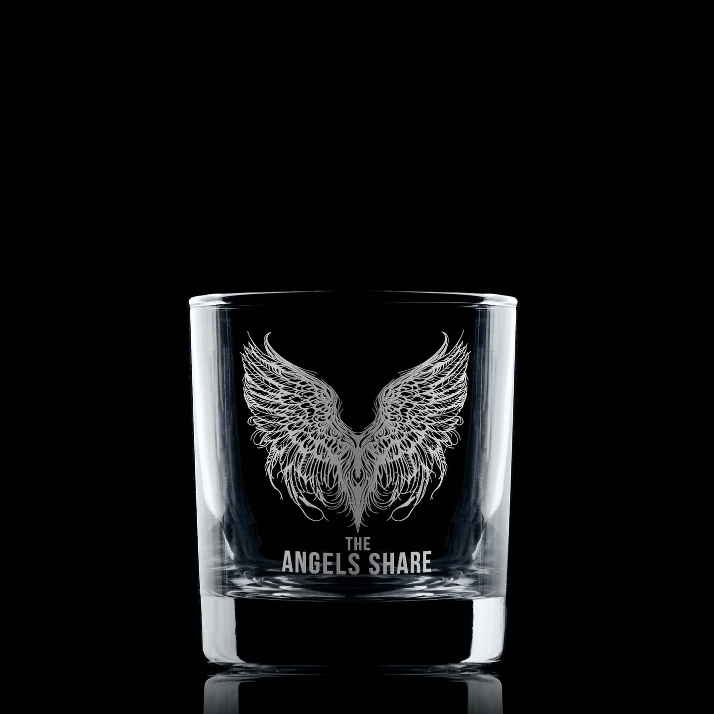Whisky glass engraved with an intricate illustration of angels wings and the words The Angels Share