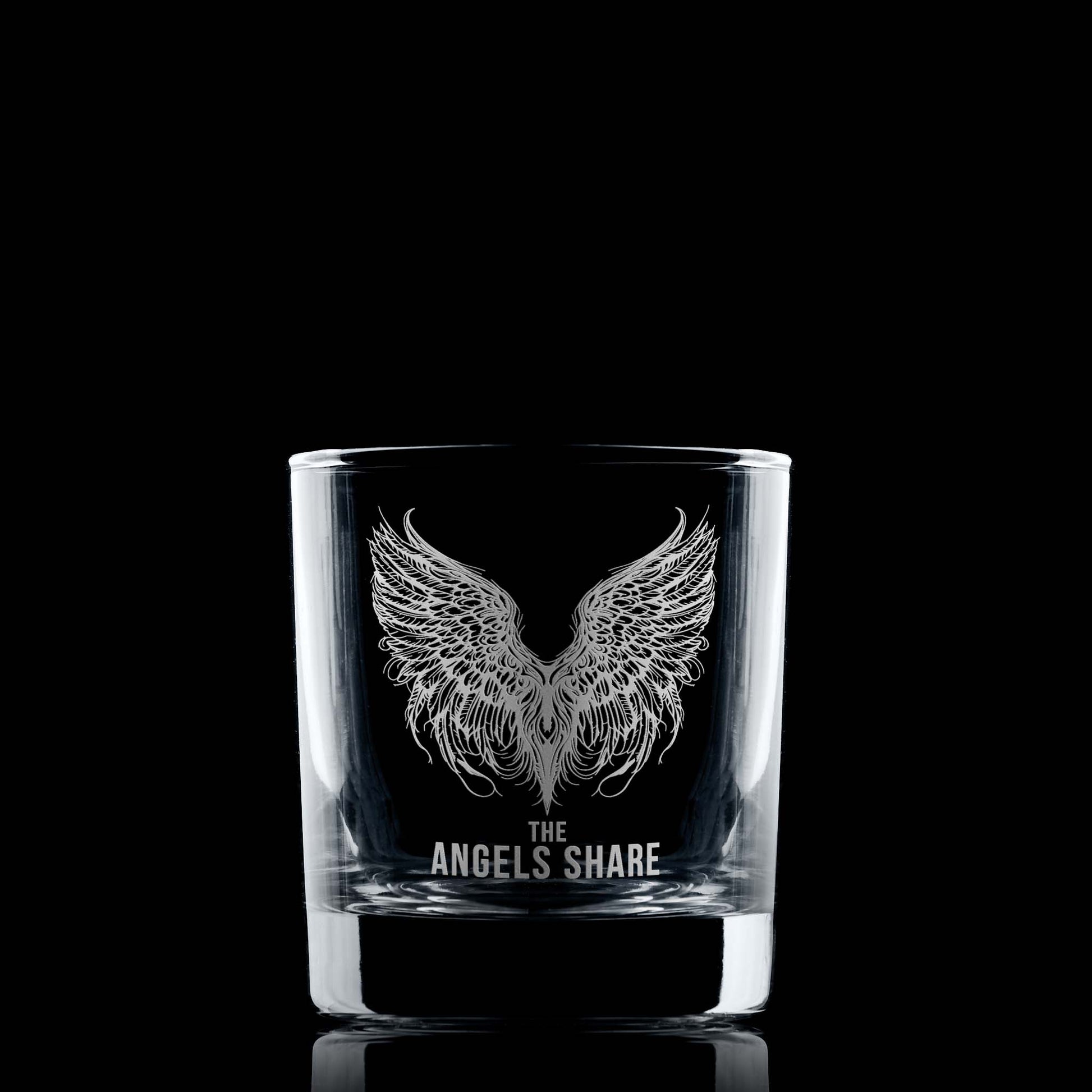 Whisky glass engraved with an intricate illustration of angels wings and the words The Angels Share