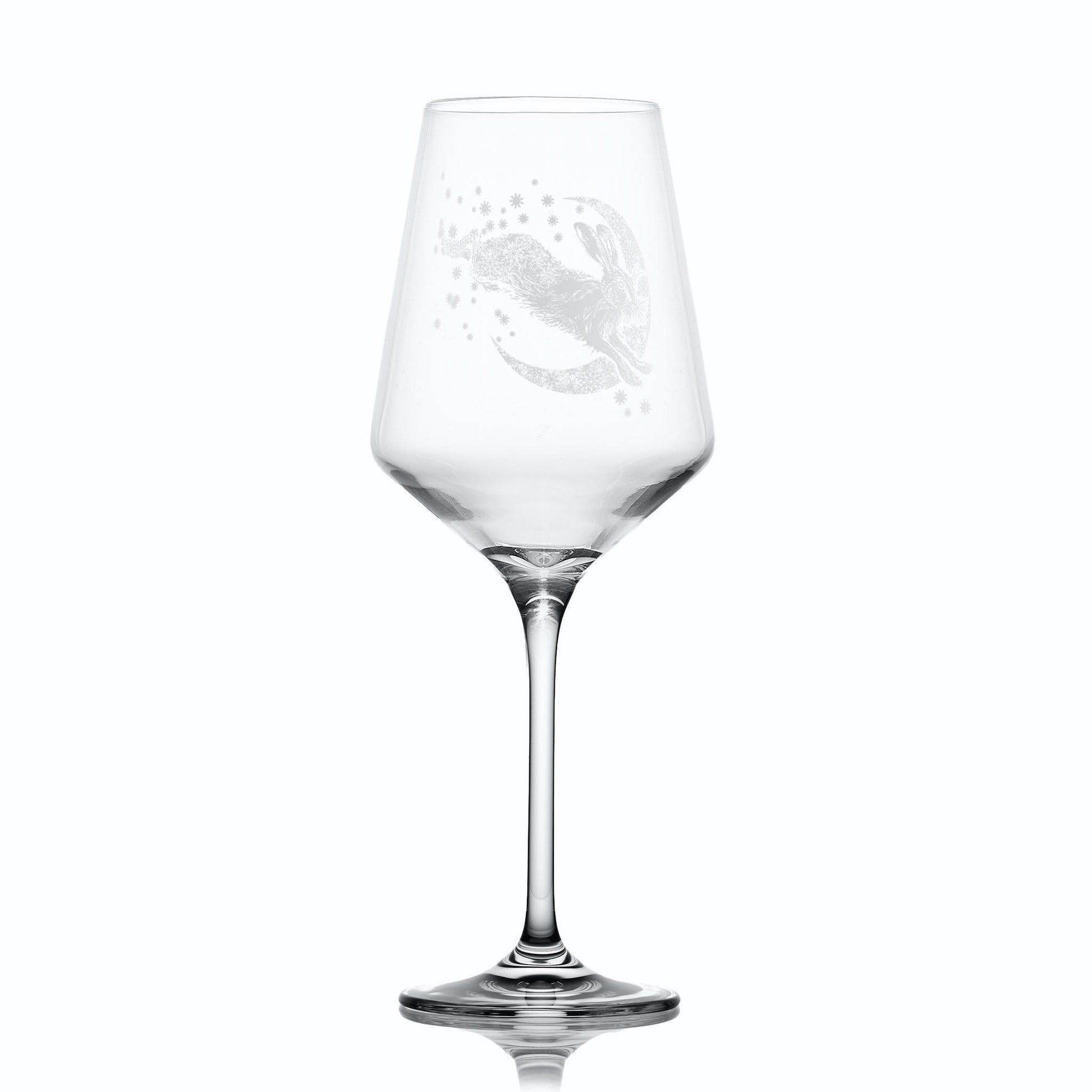 Wine glass with intricate hare, moon and stars design on a white background