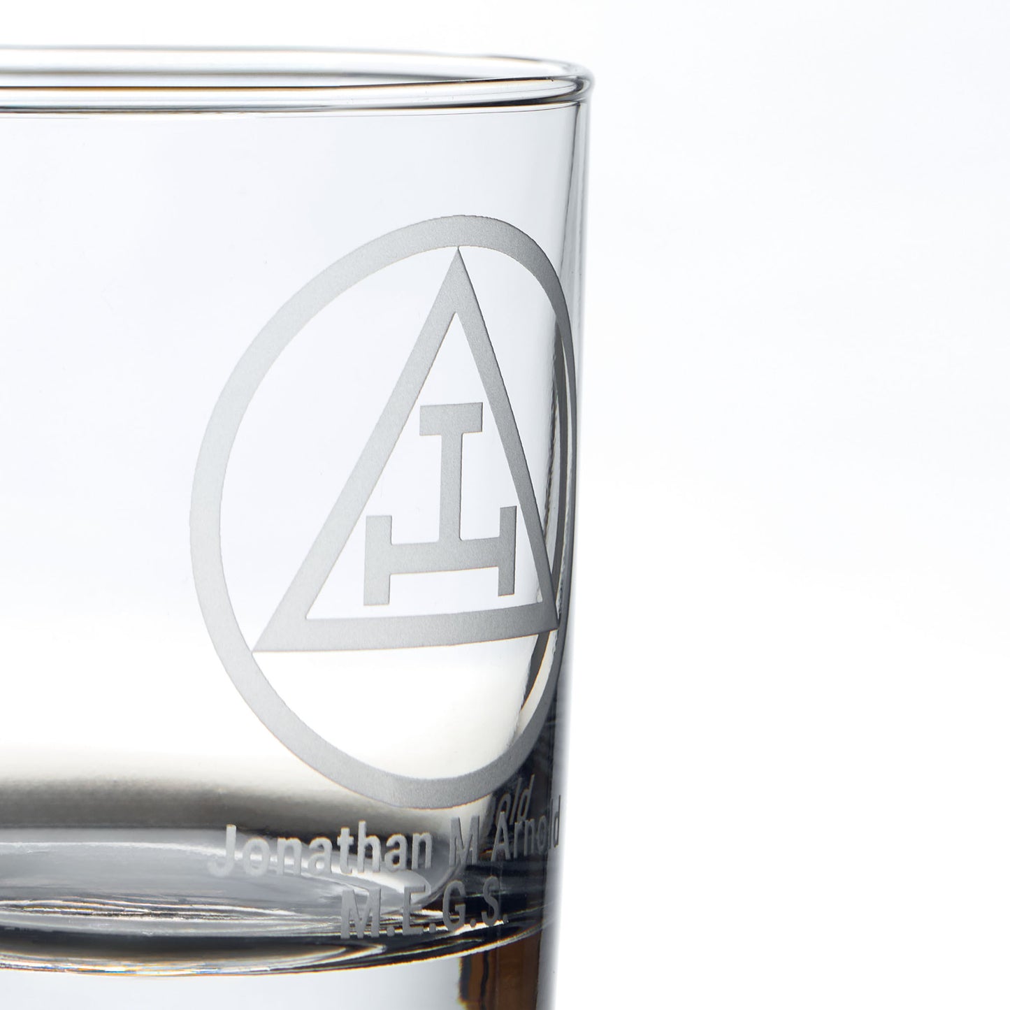 Detail of masonic whisky glass engraved with the Triple Tau symbol and personalised with name and initials