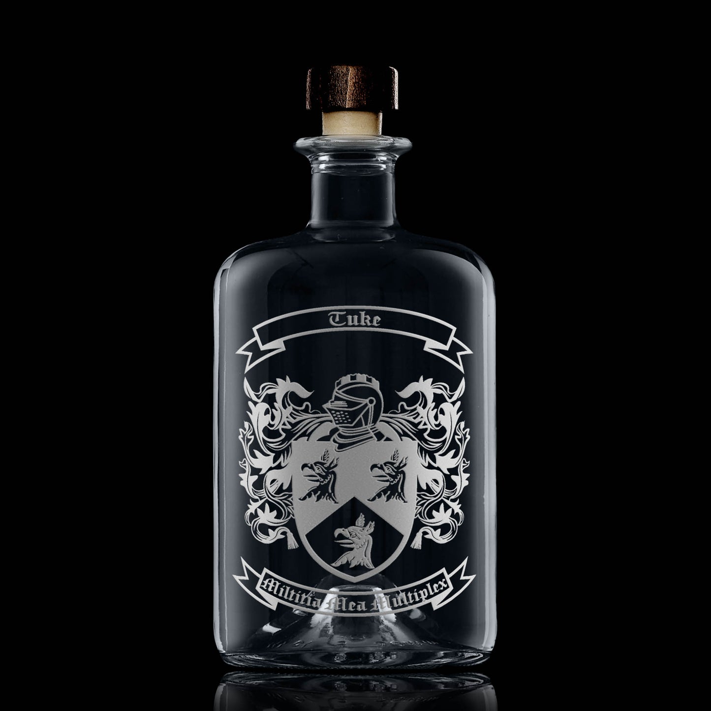Hand-engraved heraldic crest on apothecary-style glass decanter — satin sandblasted finish.