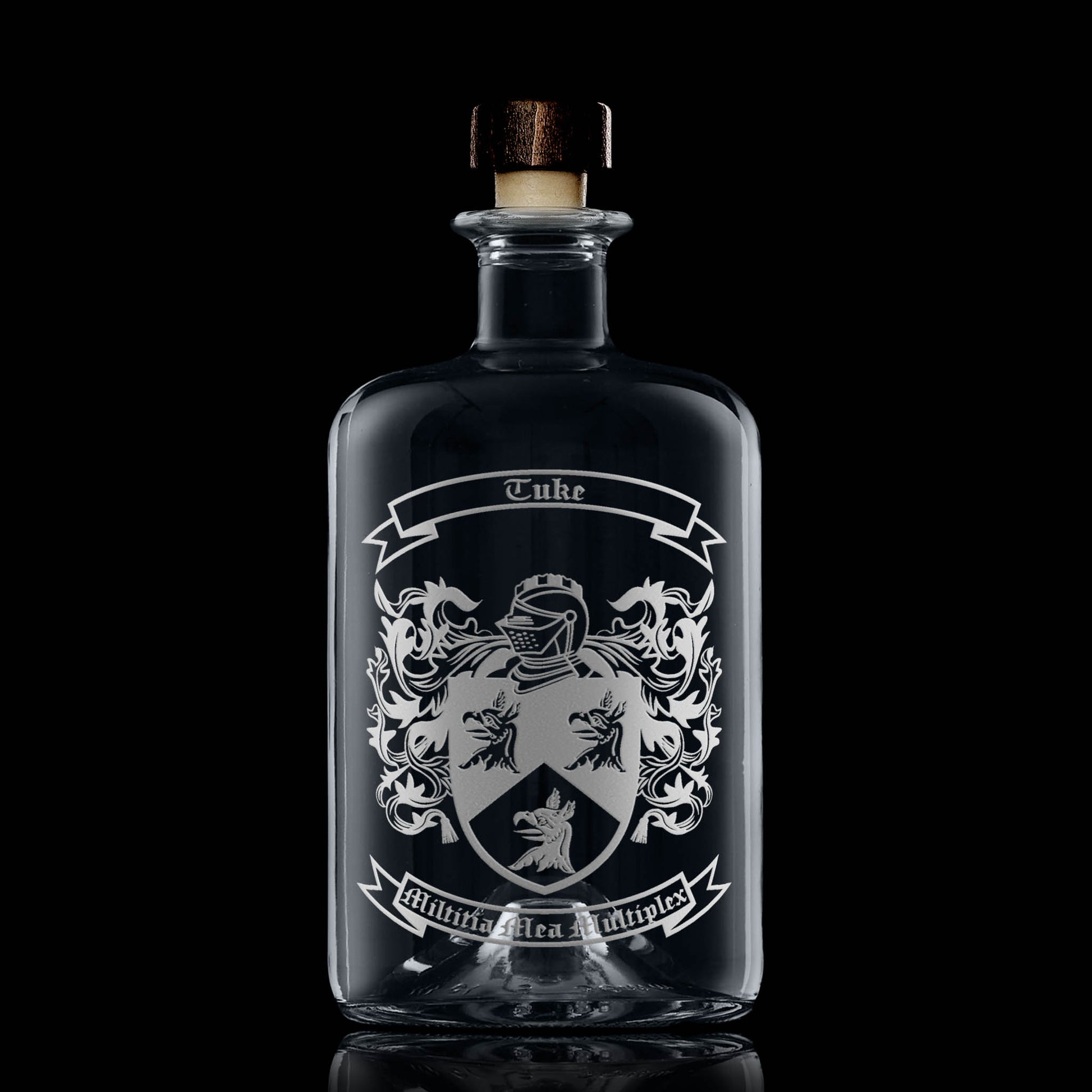 Hand-engraved heraldic crest on apothecary-style glass decanter — satin sandblasted finish.