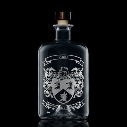 Hand-engraved heraldic crest on apothecary-style glass decanter — satin sandblasted finish.