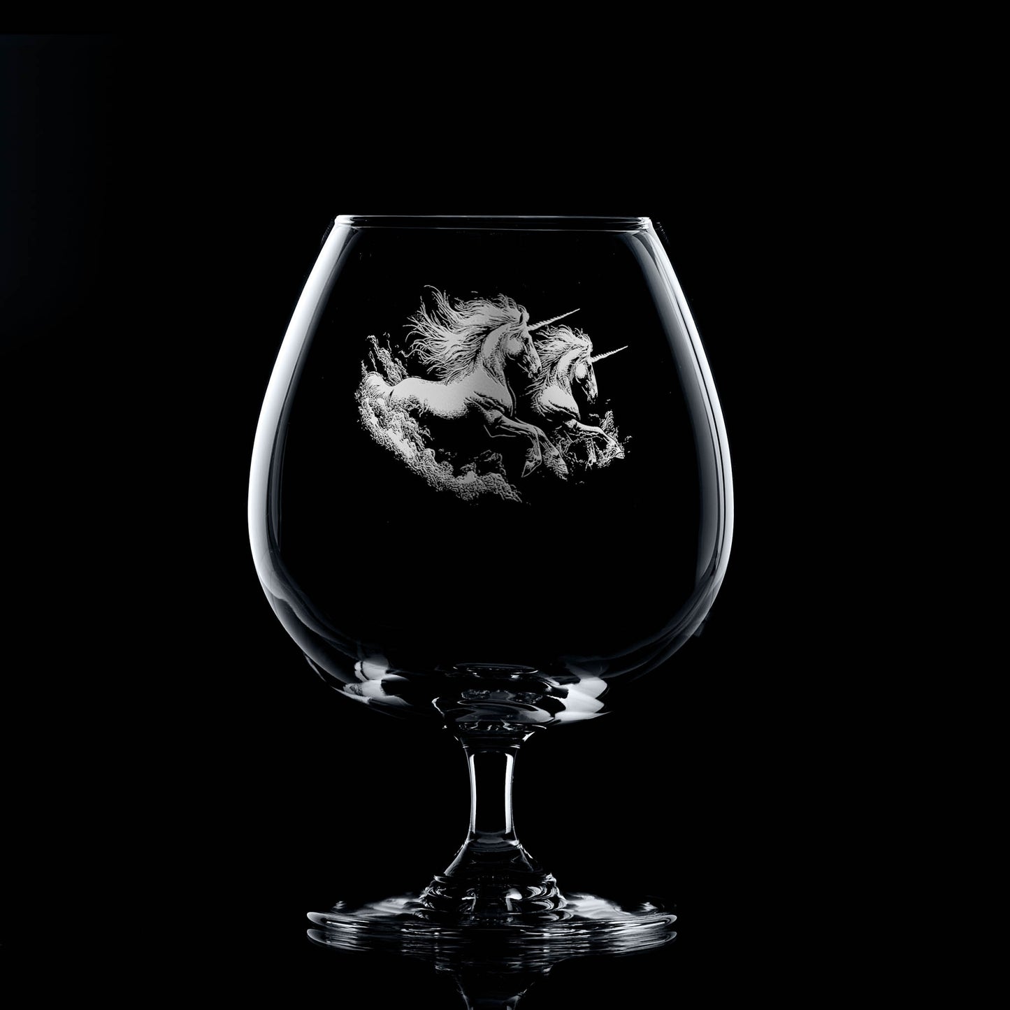 Brandy glass engraved with two galloping unicorns and swirling dust