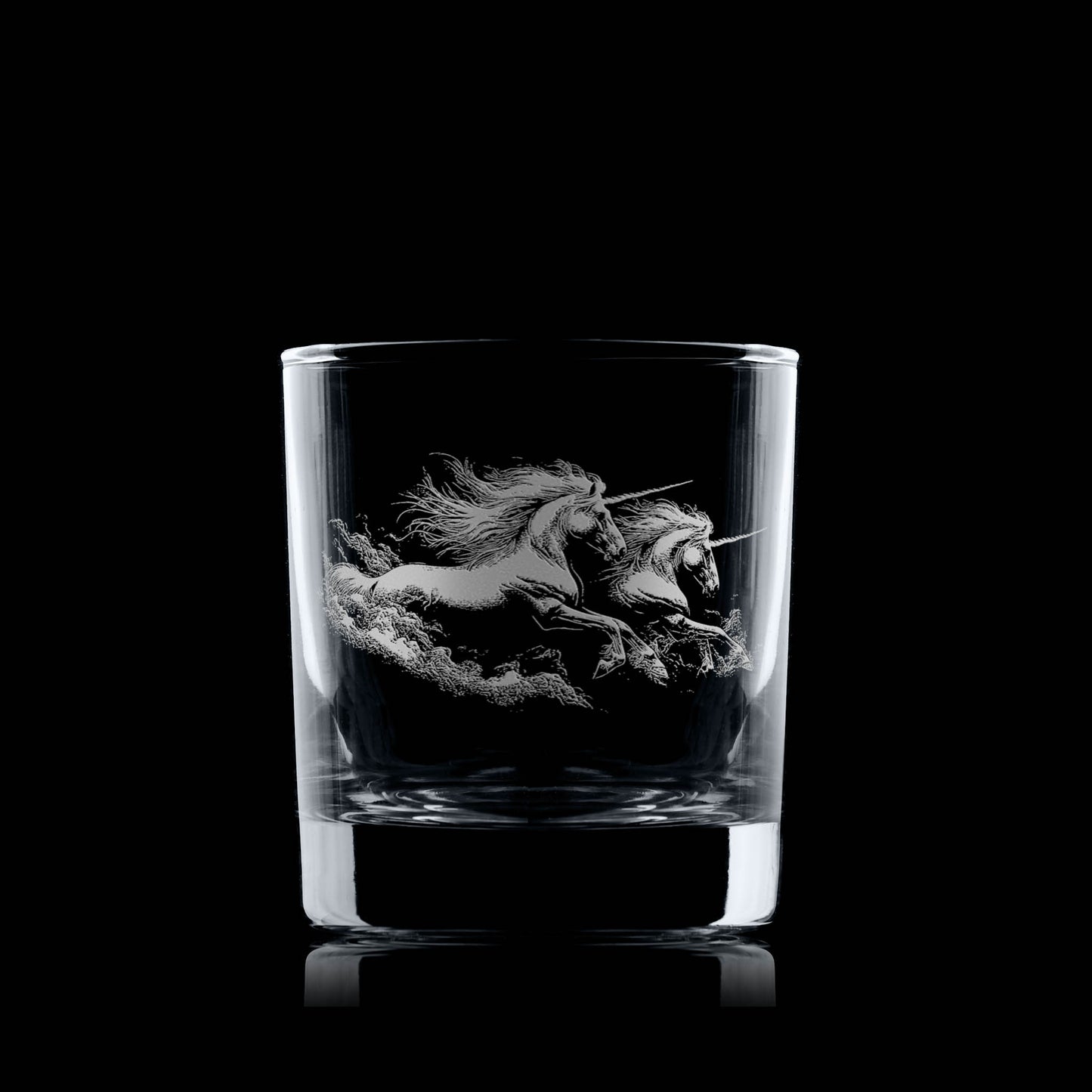 Clear glass tumbler with a engraved unicorn design on a black background