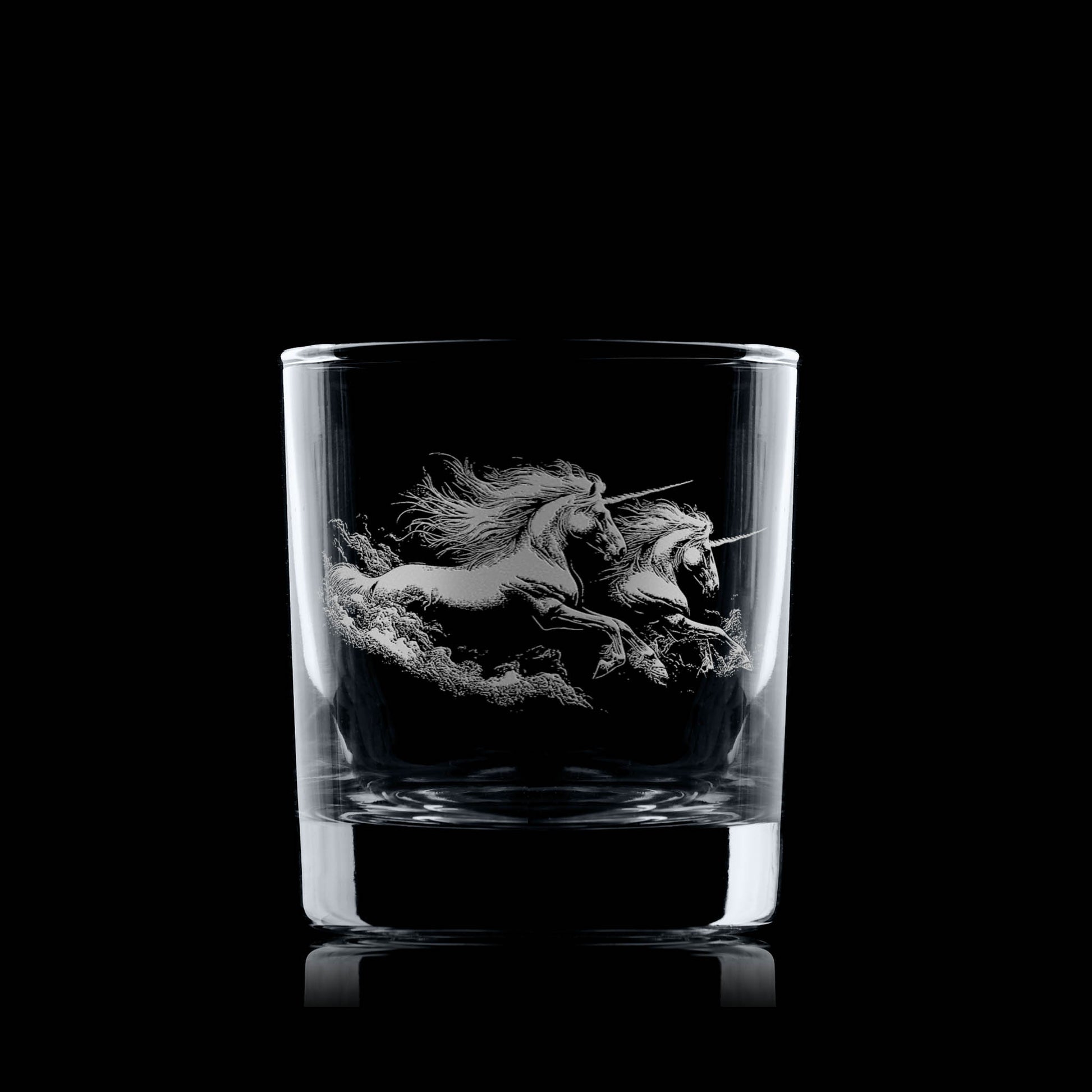 Clear glass tumbler with a engraved unicorn design on a black background