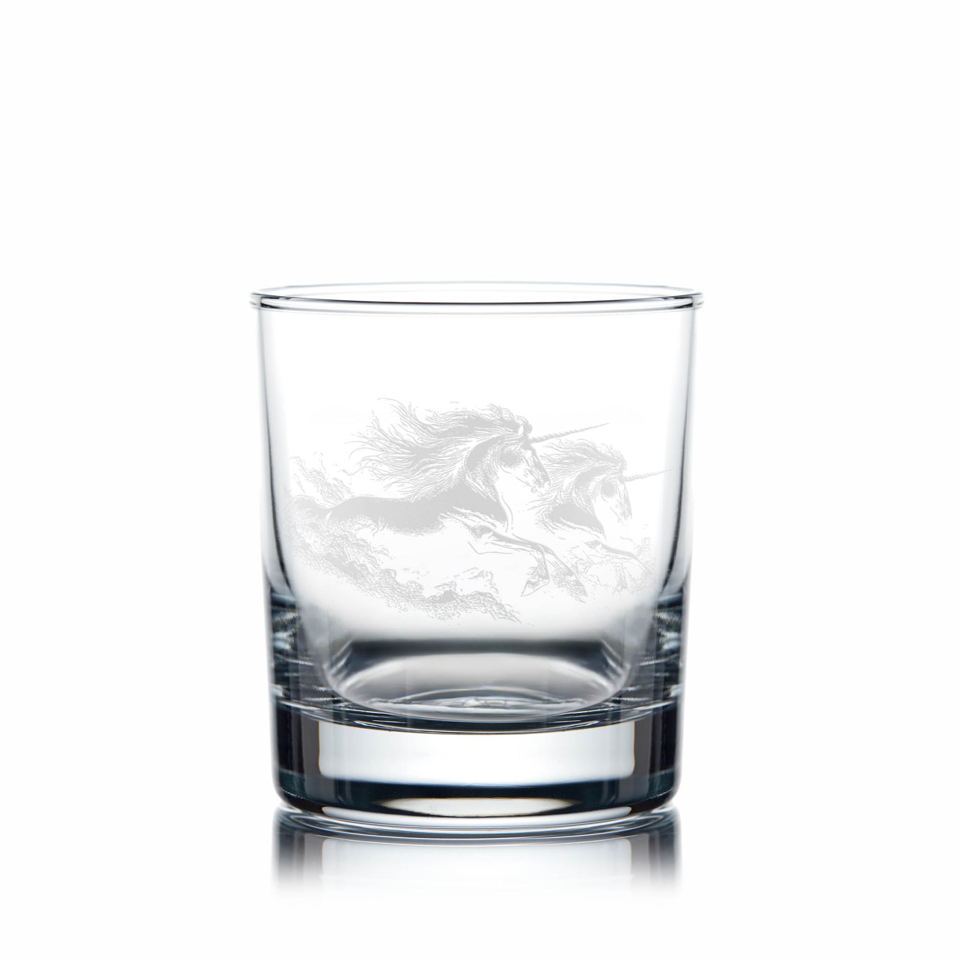 Clear glass tumbler with engraved unicorn design on a white background