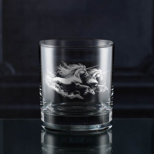Engraved whisky glass with two unicorns galloping through swirling dust or clouds