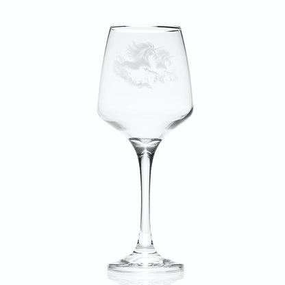 Clear wine glass with a mythical scottish horse engraving on a white background