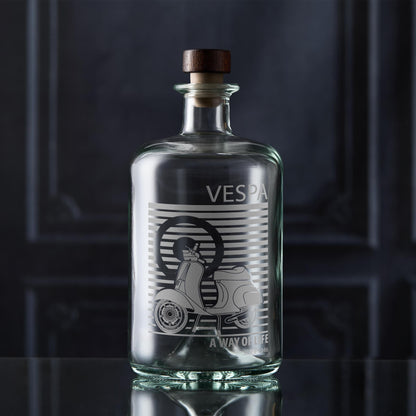 Clear glass bottle with Vespa Scooter on a dark background