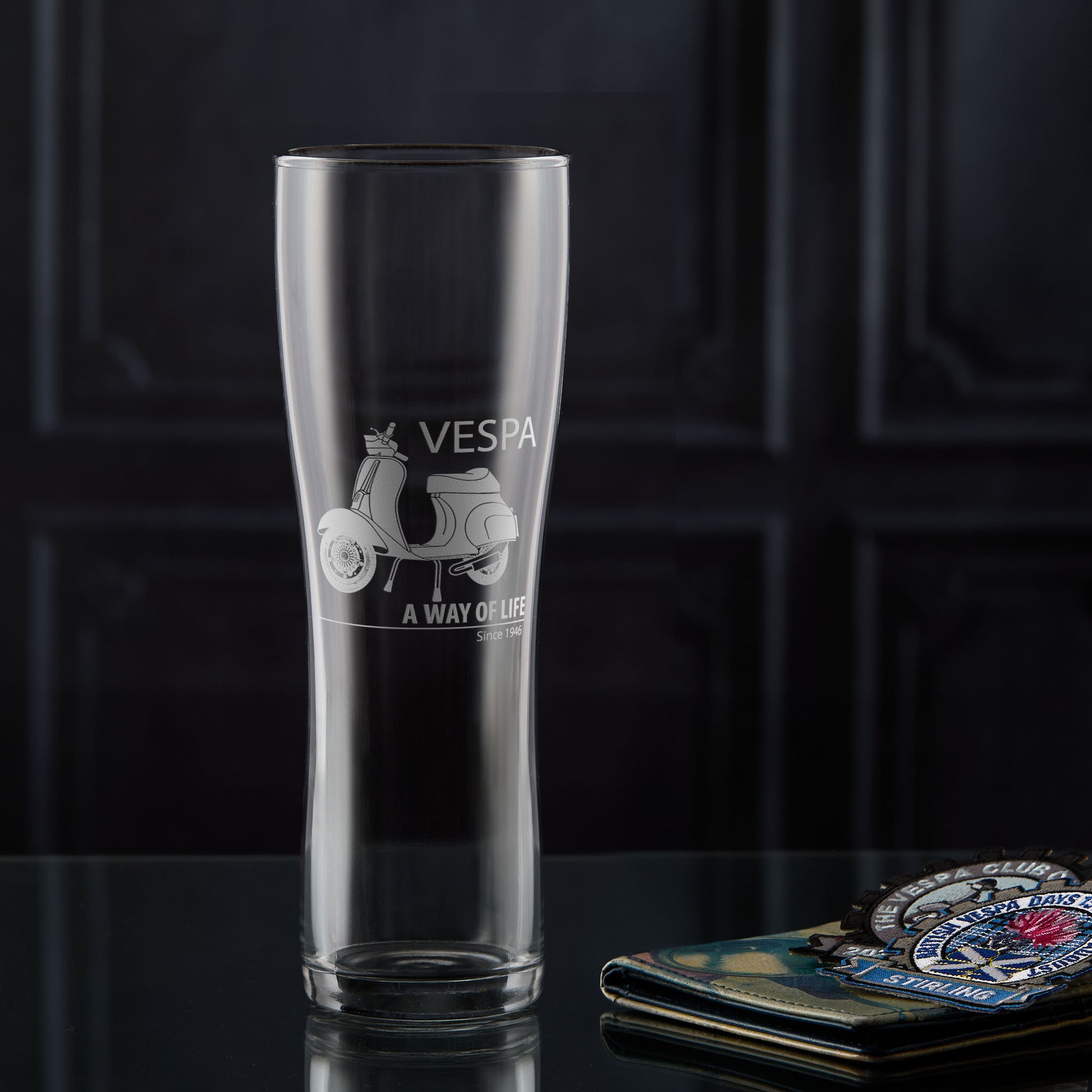 Pint glass engraved with a Vespa 50 Special scooter and 'A Way of Life' text on a dark background