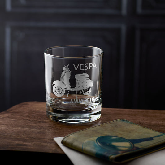 Whisky glass with a Vespa 50 special scooter engraving on a wooden surface with a personalised message