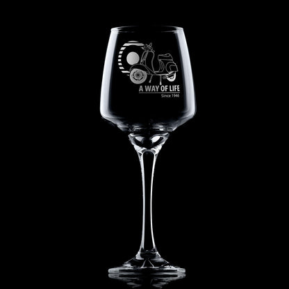 Personalised wine glass engraved with Vespa 50 Special and Mod target design, shown on black background