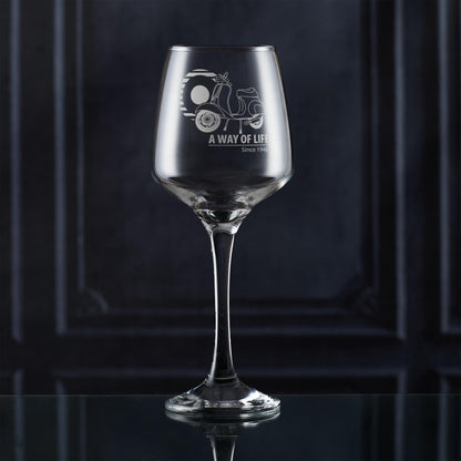 Engraved Vespa 50 Special wine glass with A Way of Life Since 1946 slogan, styled on dark background