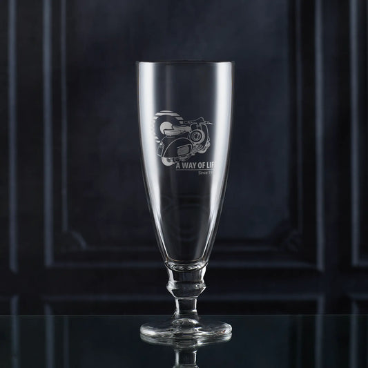 Stemmed beer glass engraved with Vespa GL scooter and Mod target, photographed on dark background