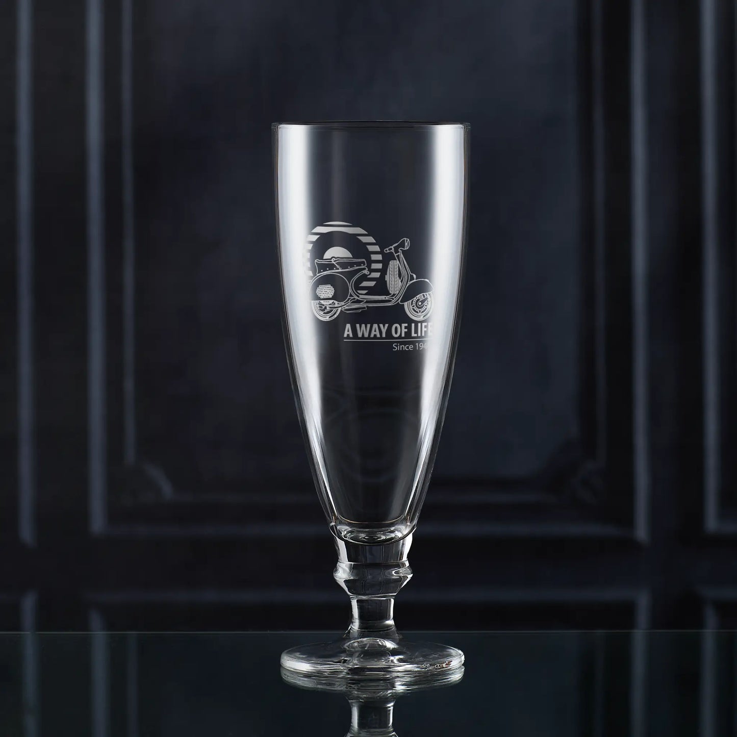 Stemmed beer glass engraved with Vespa GS150 scooter and Mod target, shown against dark background