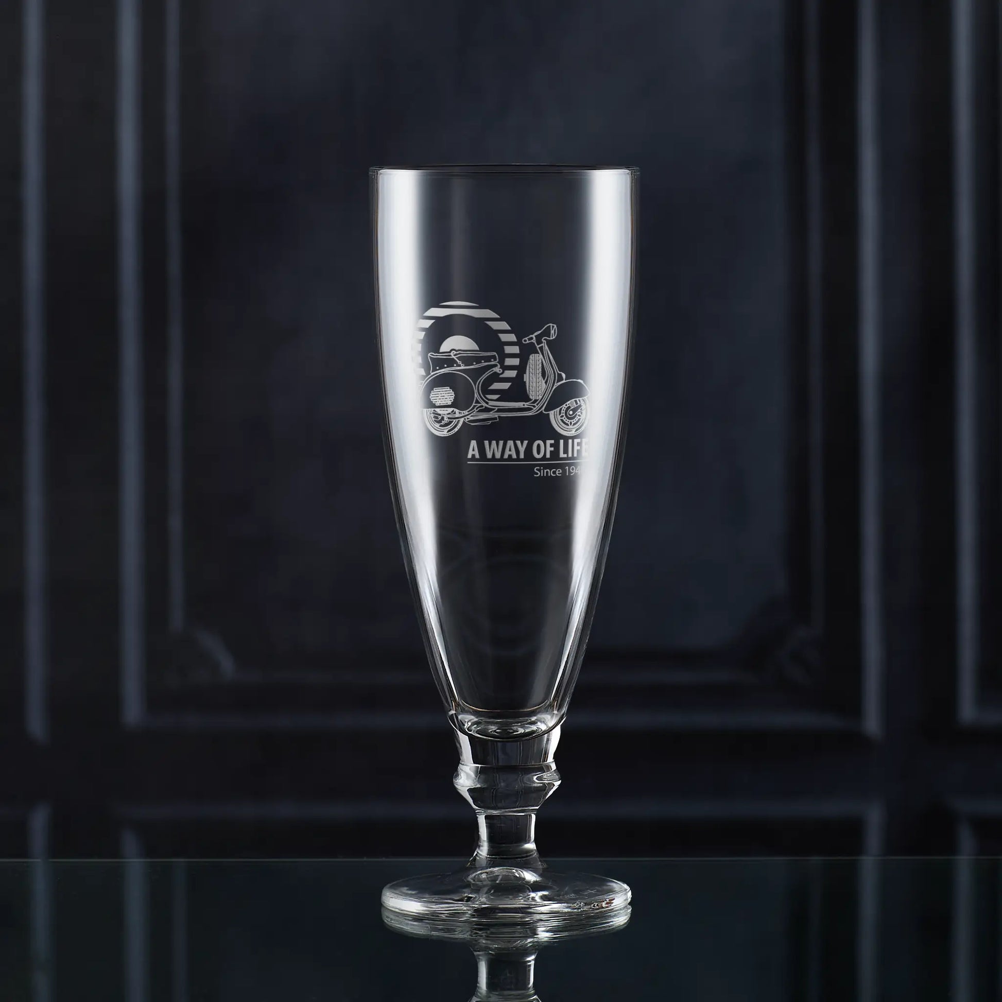 Stemmed beer glass engraved with Vespa GS150 scooter and Mod target, shown against dark background