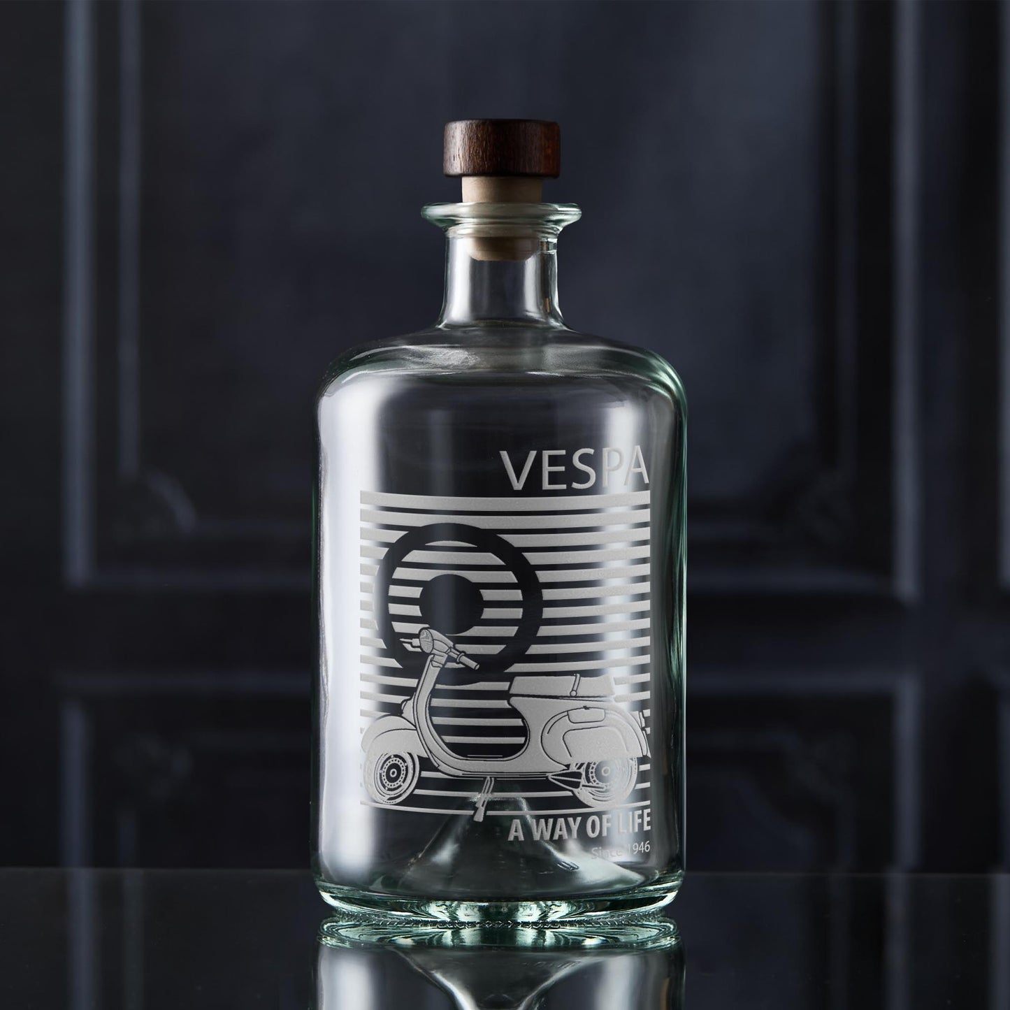 Vespa decanter bottle with wooden cap on a dark background
