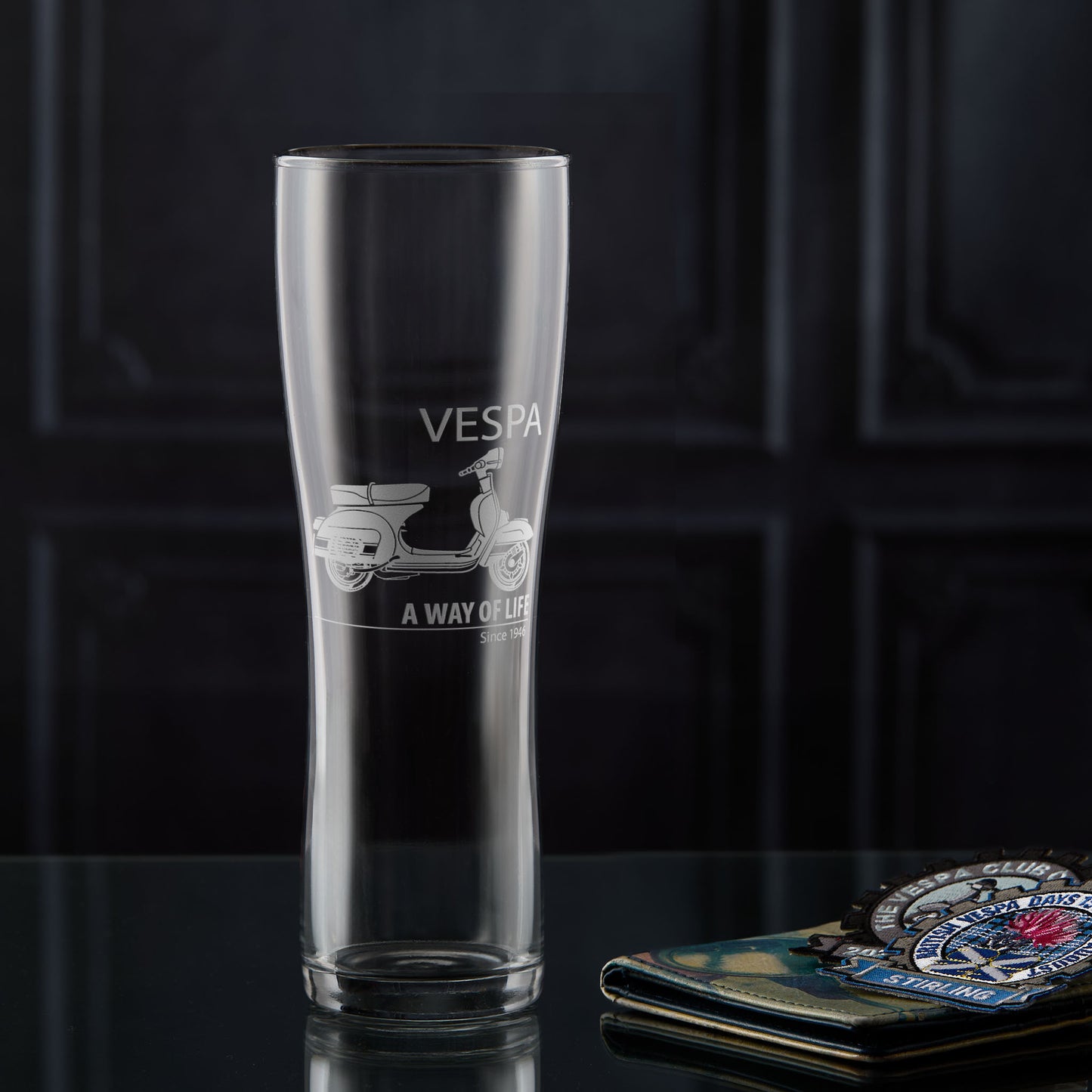 Pint glass engraved with a Vespa Rally 200 scooter and 'A Way of Life' text on a dark background
