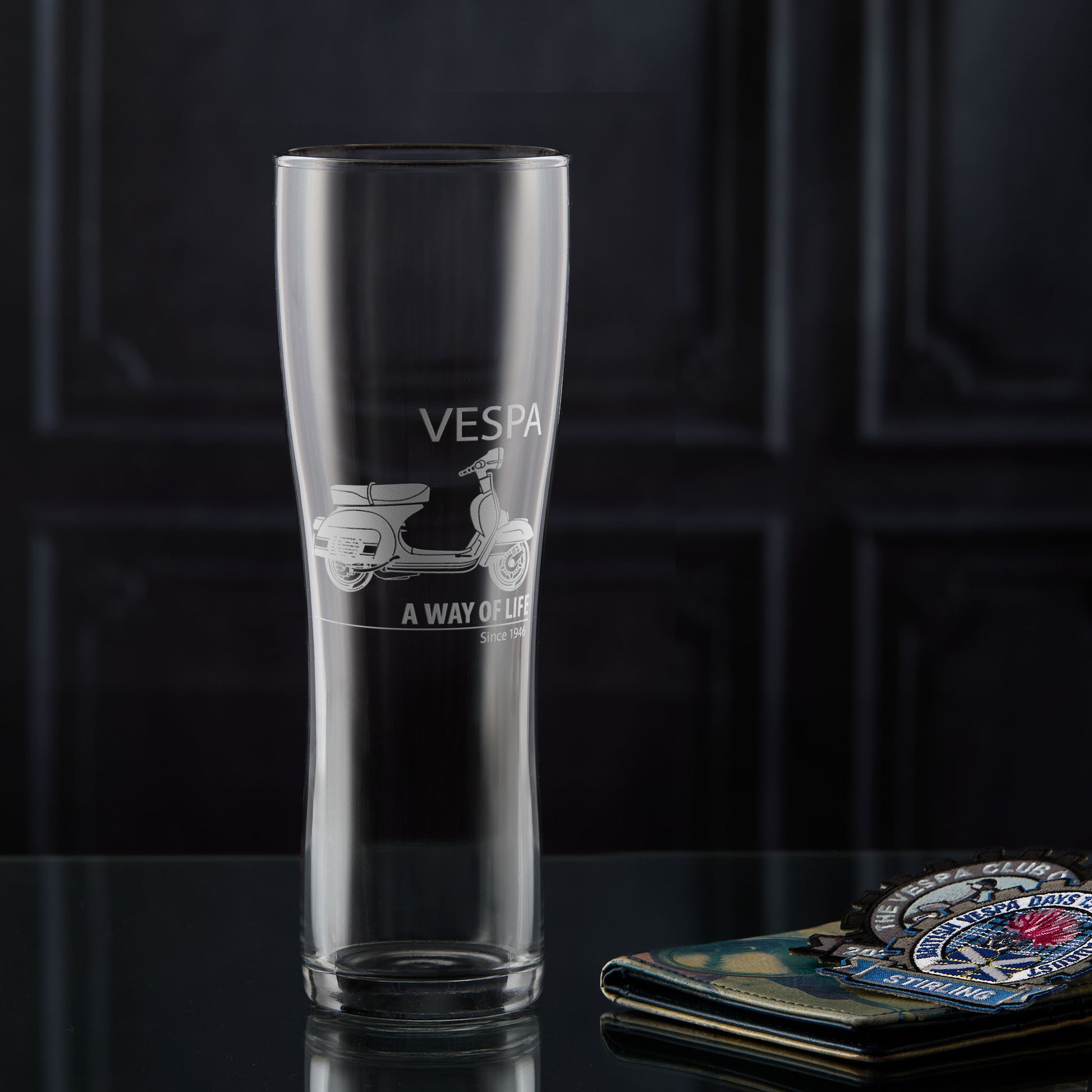 Pint glass engraved with a Vespa Rally 200 scooter and 'A Way of Life' text on a dark background