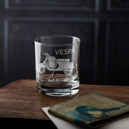 Engraved whisky glass with Vespa SS90 scooter engraving on a wooden surface