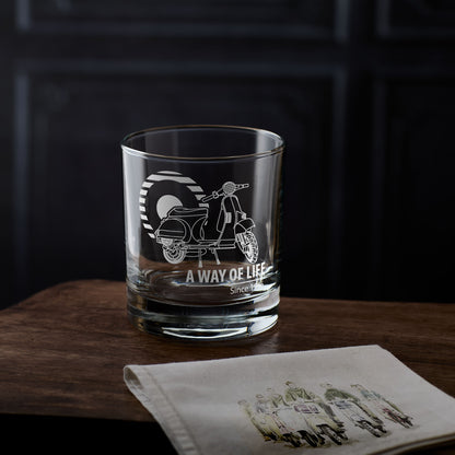 Vespa t5 whisky glass with scooter design and 'A way of Life' text on a wooden surface with a dark background