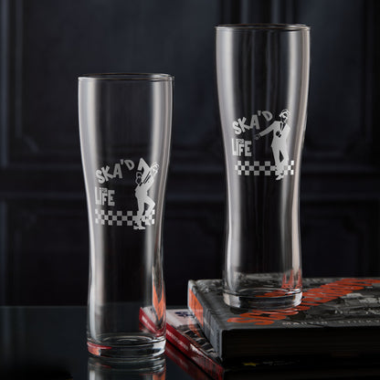 Two Walt Jabsco pint glasses with 'Ska'd for Life' text and checkered design on a dark background