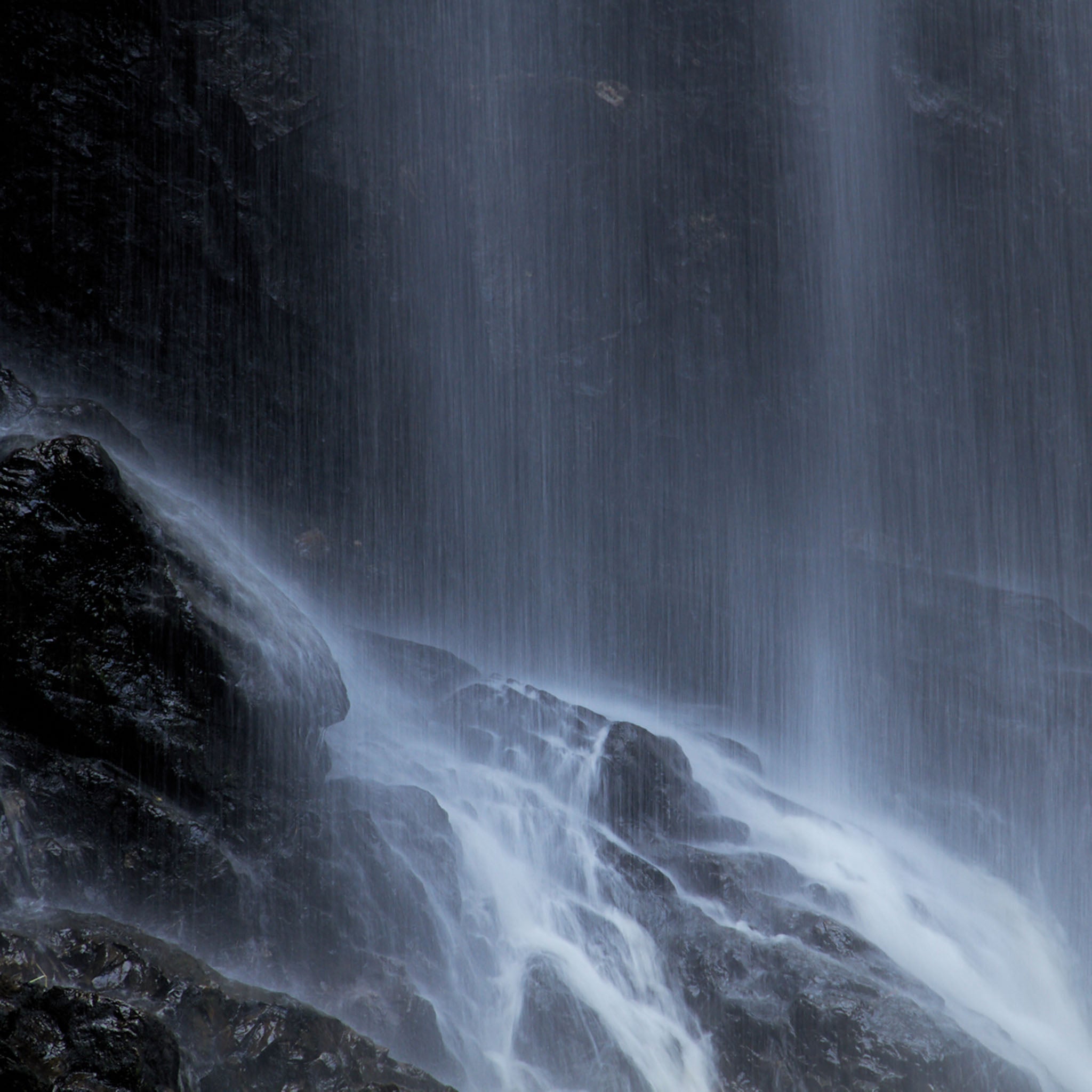 Waterfall cascading down rocky terrain