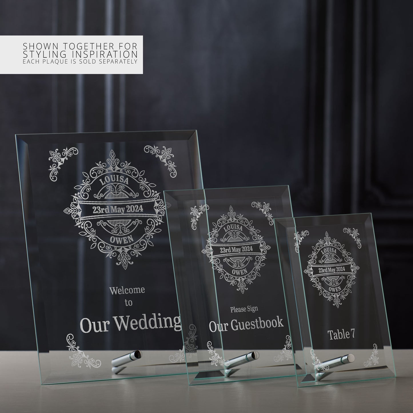 Three glass wedding signs with personalised text on a dark background