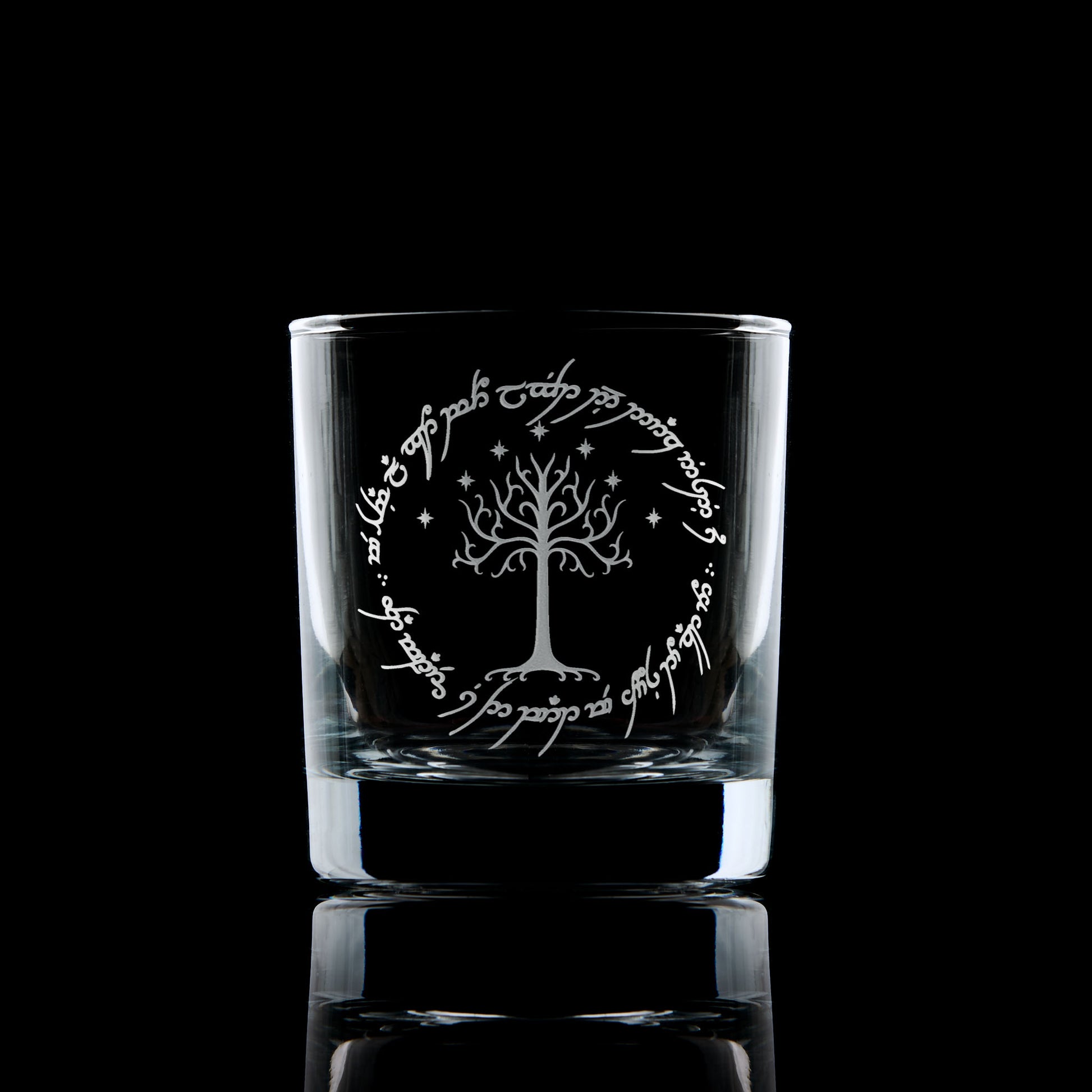 whisky glass engraved with lord of the rings elvish font and a tree