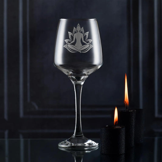 Wine glass engraved with a woman practicing Yoga set against a lotus flower