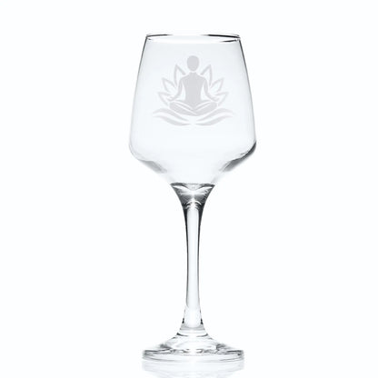 Wine glass engraved with man practicing Yoga set against a lotus flower
